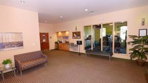 Common area with bench, couch, and water fountains