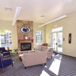 Sitting area with fireplace, large windows, and TV