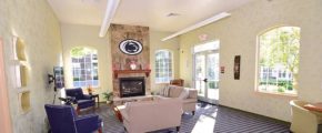 Sitting area with fireplace, large windows, and TV