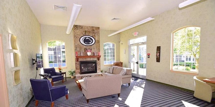 Sitting area with fireplace, large windows, and TV