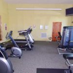 Exercise room with fitness equipment and TV