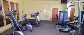 Exercise room with fitness equipment and TV