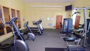 Exercise room with fitness equipment and TV