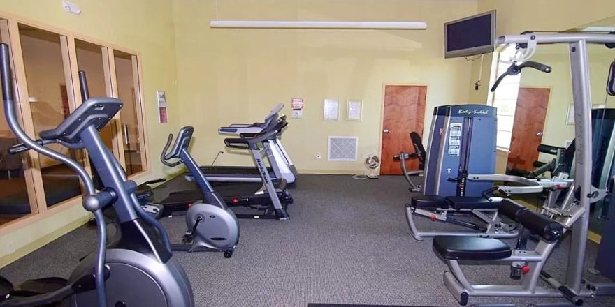 Exercise room with fitness equipment and TV