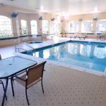 Pool area with lounge chairs and patio tables and seating