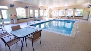 Pool area with lounge chairs and patio tables and seating