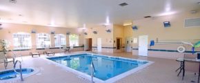 Pool area with lounge chairs and patio tables and seating