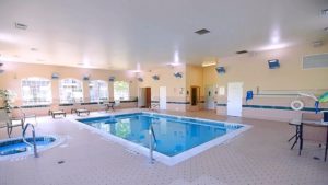 Pool area with lounge chairs and patio tables and seating