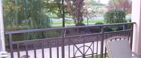 Balcony with railing and patio chair