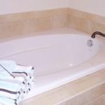 Soaking tub with tile surround and towels