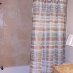 Bathroom with vanity, toilet, and tub/shower combo