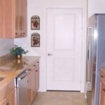 Kitchen with double sink, stainless steel appliances, and wood-tone cabinets