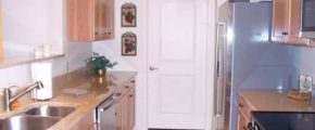 Kitchen with double sink, stainless steel appliances, and wood-tone cabinets