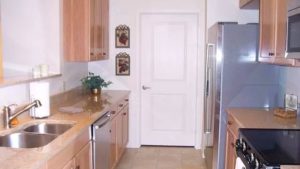 Kitchen with double sink, stainless steel appliances, and wood-tone cabinets