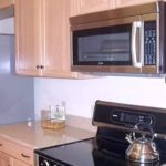 Kitchen with double sink, stainless steel appliances, and wood-tone cabinets