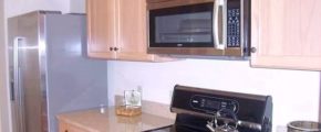 Kitchen with double sink, stainless steel appliances, and wood-tone cabinets