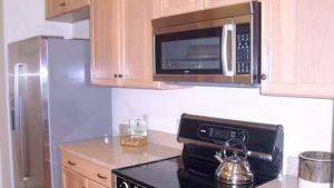 Kitchen with double sink, stainless steel appliances, and wood-tone cabinets