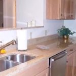 Kitchen with double sink, stainless steel appliances, and wood-tone cabinets