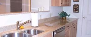 Kitchen with double sink, stainless steel appliances, and wood-tone cabinets