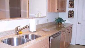 Kitchen with double sink, stainless steel appliances, and wood-tone cabinets