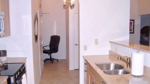 Kitchen with double sink, stainless steel appliances, and wood-tone cabinets