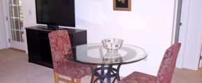 Table with two chairs and a bowl