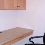 Built-in desk with cabinet and office chair