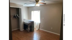 Bedroom with closet, piano, and egress window