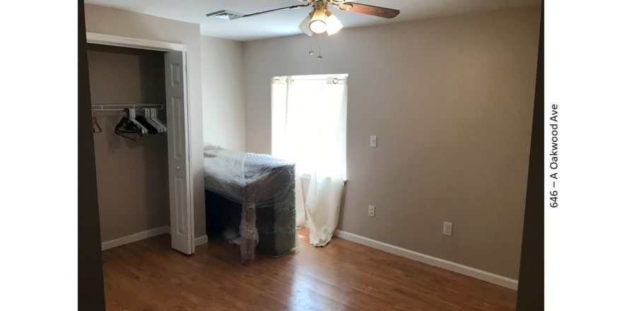 Bedroom with closet, piano, and egress window