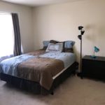 Bedroom with bed, nightstand, and lamps