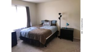 Bedroom with bed, nightstand, and lamps