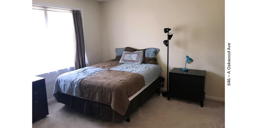 Bedroom with bed, nightstand, and lamps