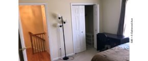 Bedroom with closet, desk with chair, lamp, and bed