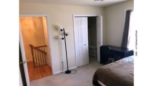 Bedroom with closet, desk with chair, lamp, and bed