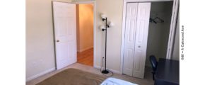 Bedroom with desk and chair, closet, and lamp