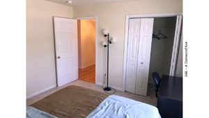 Bedroom with desk and chair, closet, and lamp