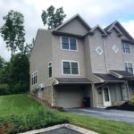 Front exterior of end-unit townhouse with garage and driveway