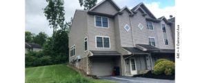 Front exterior of end-unit townhouse with garage and driveway