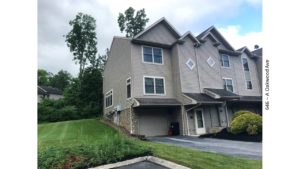 Front exterior of end-unit townhouse with garage and driveway