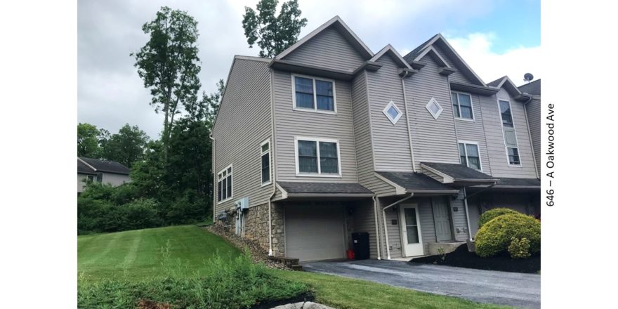 Front exterior of end-unit townhouse with garage and driveway