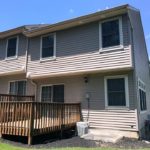 Back exterior of end-unit townhouse with deck