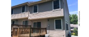 Back exterior of end-unit townhouse with deck