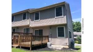 Back exterior of end-unit townhouse with deck