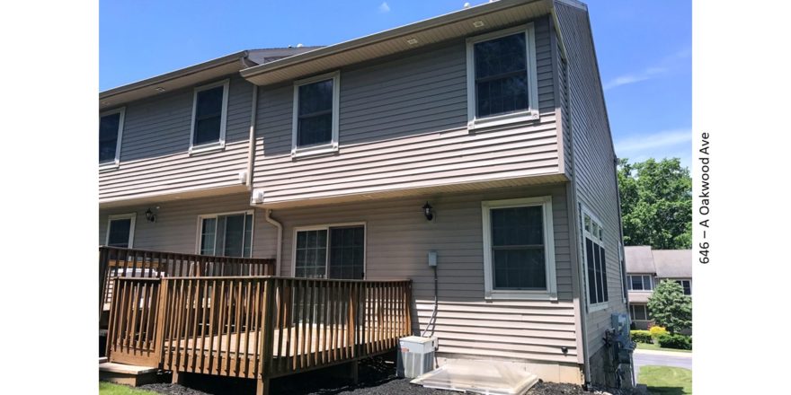 Back exterior of end-unit townhouse with deck