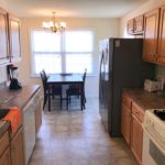 Kitchen with cabinets, appliances, and table