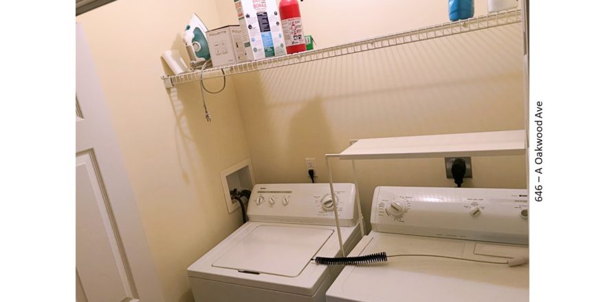 Laundry closet with side-by-side washer and dryer and shelving
