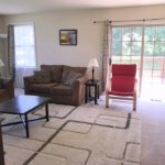 Furnished living room with door to a deck