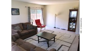 Furnished living room with door to a deck