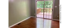 Dining area with wood-style floors and large glass slider onto a wooden deck