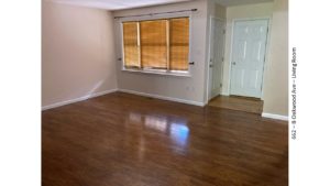 Living room with wood-style flooring and large window